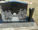 For highly detailed pictures you can have them lasered onto your memorial, black is the best color for this option.  This family even added a cowboy boot vase for their loved one.